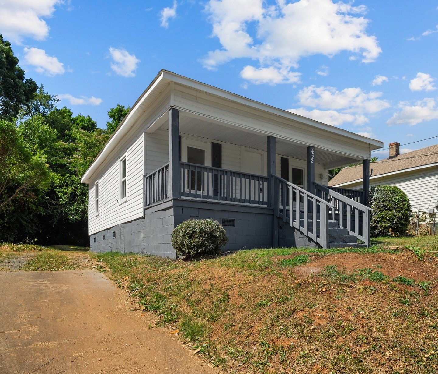 Well-maintained white bungalow with porch, representative of properties RMBM Inc works with